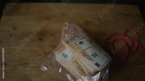 Corrupt businessman counting euro banknotes and hiding cash in envelopes 