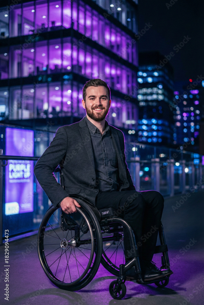 Obraz premium Professional in Wheelchair with Purple Lighting for Disability Day