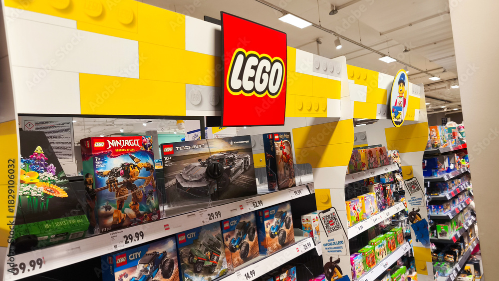 Fototapeta premium Potsdam, Germany - October 21, 2025: LEGO display in a retail store showcasing various sets including Ninjago and City, highlighting vibrant colors and playful atmosphere for children