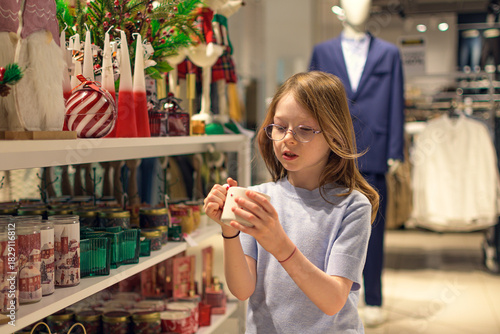 Wallpaper Mural A girl in a store among Christmas decorations. Preparing for the New Year and Christmas. Buying decorations and gifts. Torontodigital.ca