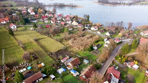 Aerial Zełwagi Poland rustic farm village lake 1. Farming fishing town, tourist destination in lake district. First building of The Church of Jesus Christ of Latter-day Saints in central Europe.