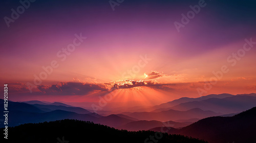 Stunning sunset behind mountain silhouettes.