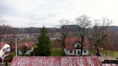 Aerial Zełwagi Poland rustic village climb. Farming fishing town, tourist destination in lake district. First building of The Church of Jesus Christ of Latter-day Saints in central Europe.