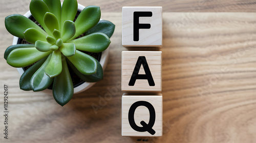 Faq wooden blocks stacked next to a succulent plant on a wooden surface frequently asked questions concept for business support and information resources