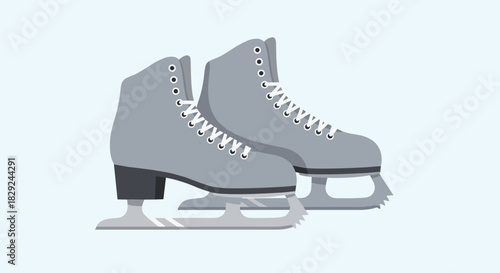 A pair of gray ice skates on a light blue background, ready for winter fun and outdoor activity, perfect for sports and recreation season.