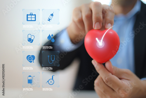 The doctor's hand is choosing the heart with medical health care icons for safety insurance for sick illness wellbeing protection plan or retirement healthy therapy treatment or health checkup