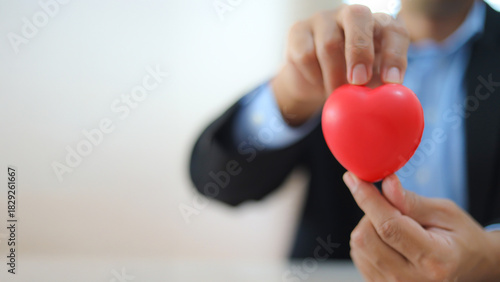 The doctor's hand is choosing the heart for medical health care for safety insurance for sick illness wellbeing protection plan or retirement healthy therapy treatment or health checkup concepts.