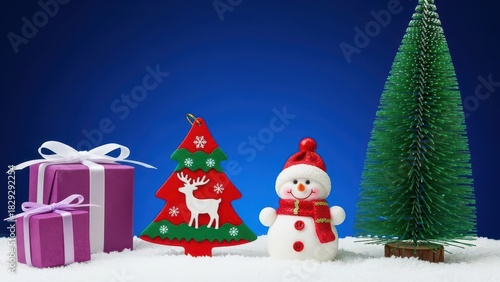 Christmas scene with snowman, gifts, and festive trees on a snowy blue background