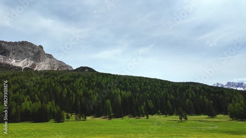 POV shot looking around a mountain with clear sky in summer, Dolomites, Passo Giau mountain pass, Italy