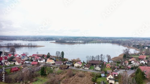 Aerial Zełwagi Poland historical village descend. Farming fishing town, tourist destination in lake district. First building of The Church of Jesus Christ of Latter-day Saints in central Europe.