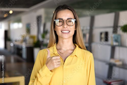Happy Caucasian woman in trendy fashionable glasses showing thumb up