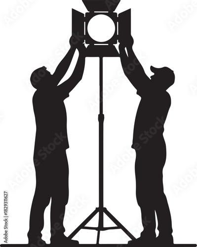 Two people adjusting studio light on stand, isolated on
