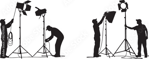 Photographers setting up studio lighting equipment, isolated on