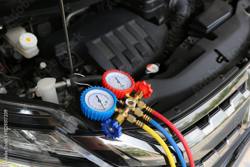 Close-up air refrigerant meter manifold gauge for car care maintenance services and check car air conditioner system heat problem and fix repairing and filling air refrigerant.