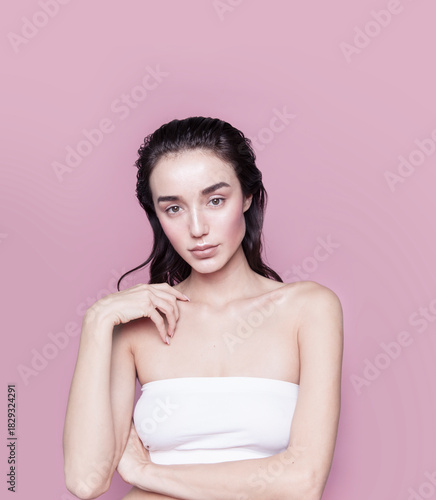 Gorgeous young woman with perfect body shape wearing lingerie underwear top looking fresh happy and healthy posing on pink background