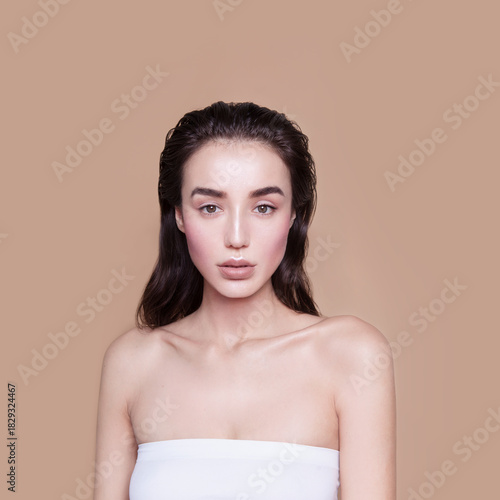 Gorgeous young woman with perfect body shape wearing lingerie underwear top looking fresh and healthy posing on beige background