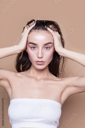 Gorgeous young woman with perfect body shape wearing lingerie underwear top looking fresh and healthy posing on beige background