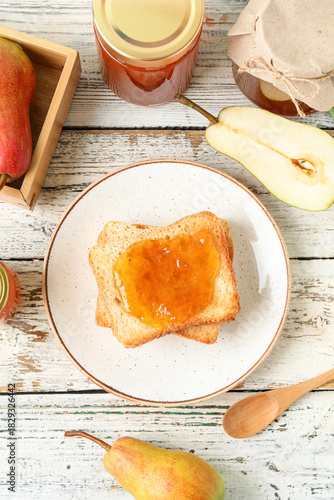Plate with tasty pear jam a...
