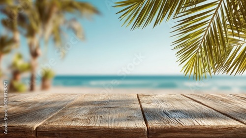 A wooden table stands in the foreground with palm leaves swaying overhead while a serene beach and the ocean stretch into the distance under a blue sky.