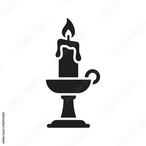 Lit candle on elegant holder symbolizing christmas light and festive holiday ambiance decoration