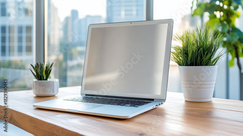 Wallpaper Mural Modern laptop on wooden desk by window with potted plants, bright workspace, calm mood Torontodigital.ca
