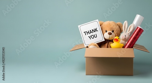 Donation Box with Toys and Thank You Sign on Blue Background, Charity and Giving Concept.