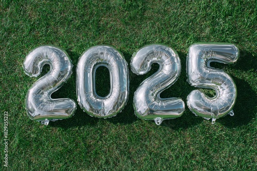 Shiny Silver Balloons Forming The Number 2025 Laying On Green Grass