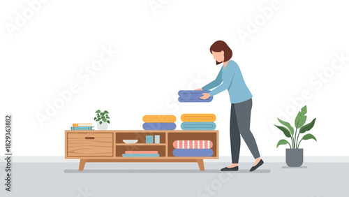 Woman organizing folded towels on wooden console with plant, bringing calm and cozy vibes to interior space, modern lifestyle and home decor elements