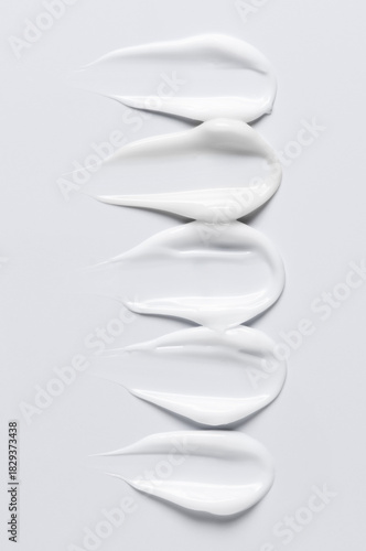 A sample of a white moisturizing cosmetic cream for the body or face with hyaluronic acid