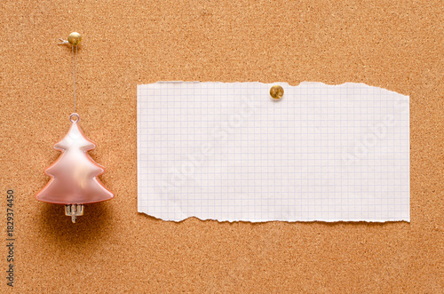 An empty record sheet and a Christmas tree toy are pinned on a cork board. Copy space