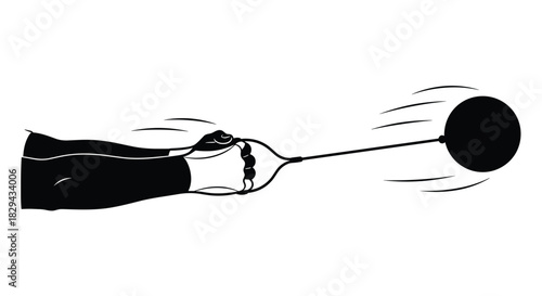 A hand holding a handle attached to a wire that is connected to a ball in motion.