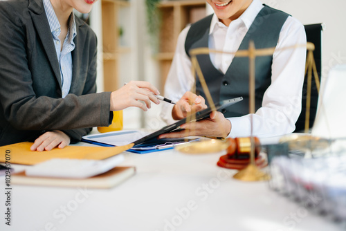 Business and lawyers discussing contract papers with brass scale on desk in office. Law, legal services, advice, justice and law concept . in office
