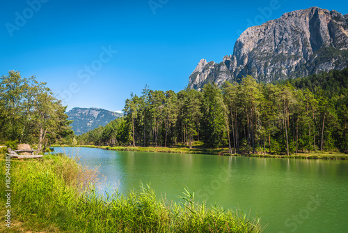 Alpine lake and high mountain ridges in Dolomites, Italy