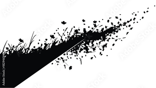 Dynamic black grass silhouette exploding into particles against a clean white background
