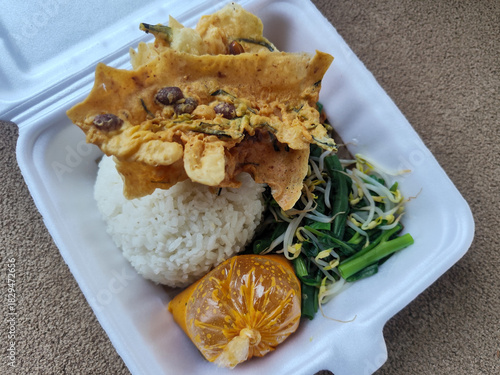 Nasi pecel and sego pecel are typical Javanese Indonesian rice dishes served with pecel sauce, vegetables and others.	