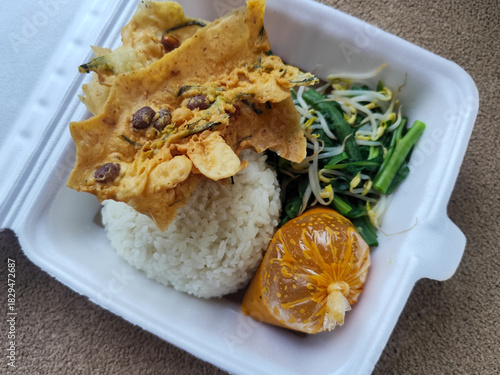 Nasi pecel and sego pecel are typical Javanese Indonesian rice dishes served with pecel sauce, vegetables and others.	
