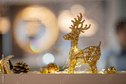 A decorative golden glitter reindeer figurine