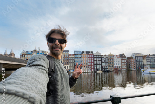 Happy tourist taking selfie picture in Amsterdam, Netherlands  - Life style tourism concept.
