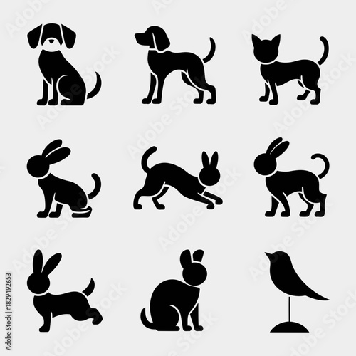 Black silhouettes of various animals including dogs, cats, rabbits, and birds in different poses isolated on