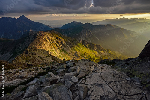Fototapeta Naklejka Na Ścianę i Meble -  Rugged mountain landscape catching golden morning light.