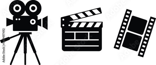 Classic filmmaking tools displayed with an old movie camera, a clapperboard, and a tilted film reel