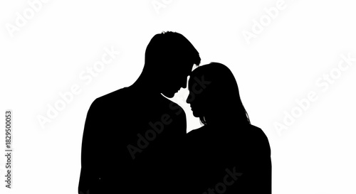 Silhouette of a couple embracing intimately against a white background.