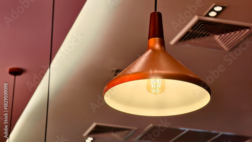 The lamp hanging from a ceiling.