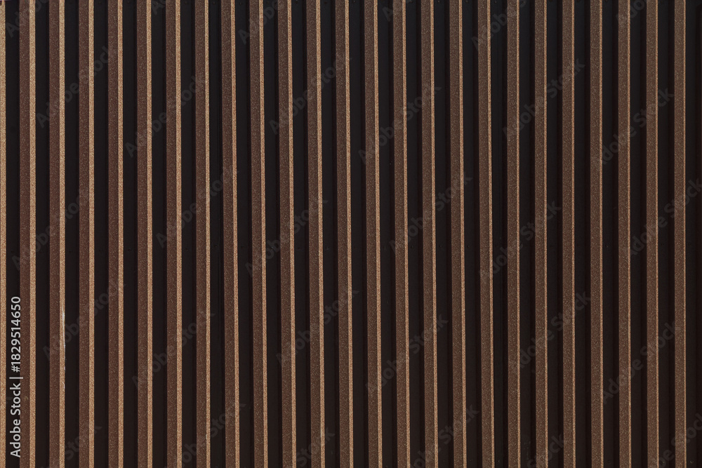 Obraz premium Black metal fence. Corrugated sheet or profiled sheet. Front. Metallic background. Striped textured backdrop