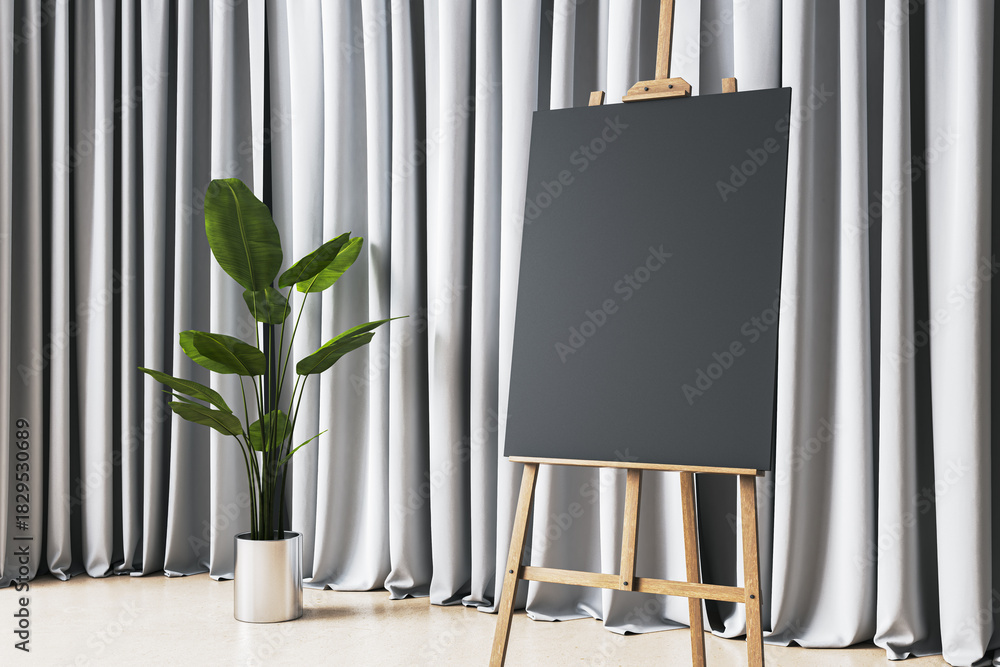 Fototapeta premium Vertical blank black canvas on wooden easel next to green potted plant, set against soft draped curtains in modern exhibition room. 3D Rendering