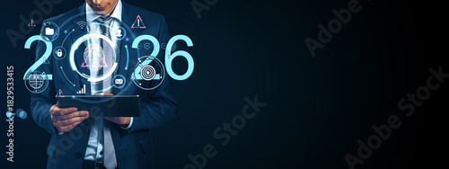 Businessman using tablet with futuristic digital interface and biometric fingerprint scan concept for 2026 cybersecurity and innovation vision.