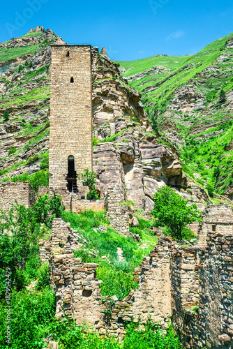 An old watchtower among the ruins of the abandoned mountain village of Kakhib on a mountainside. North Caucasus
