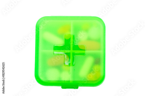 Green plastic pill container on white