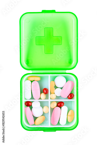 Green plastic pill container on white