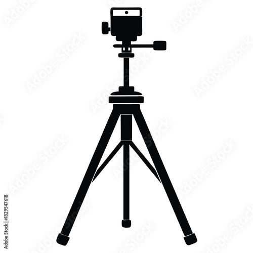 Black tripod with a simple head firmly stands against a plain white canvas